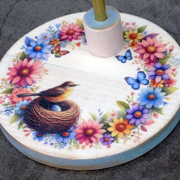 Wooden stand for Blythe dolls (and similar dolls, 1/6 scale), with a bird in its nest motif, surrounded by flowers and butterflies.